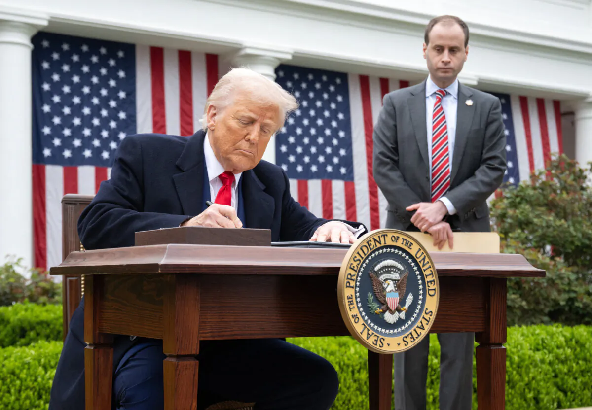 President Donald Trump signs an executive order after delivering remarks on reciprocal tariffs during an event in the Rose Garden entitled "Make America Wealthy Again" at the White House in Washington on April 2, 2025. (Saul Loeb/AFP via Getty Images)