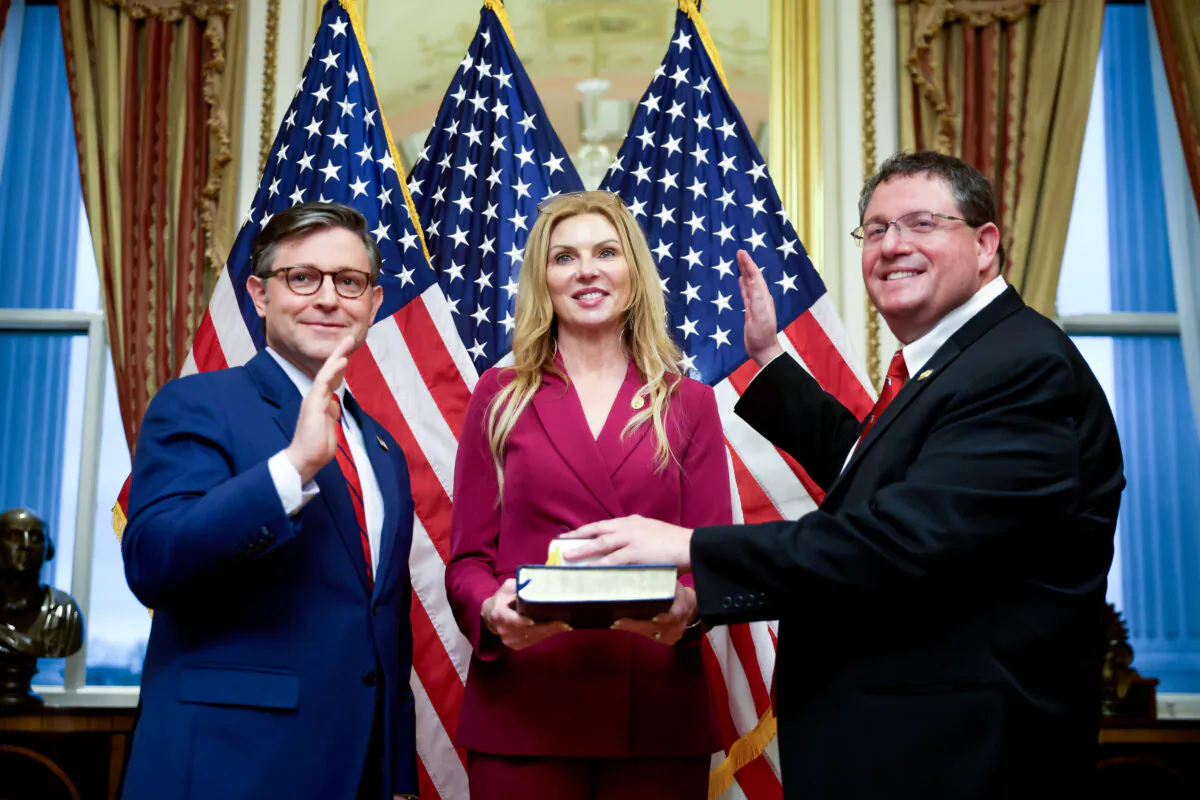 Speaker of the House Rep. Mike Johnson (R-La.) (L) participates in a ceremonial swearing-in with Rep. Randy Fine (R-Fla.) (R) with wife Wendy Fine (C) at the U.S. Capitol in Washington on April 2, 2025. (Kayla Bartkowski/Getty Images)