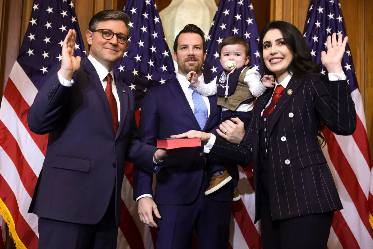 Speaker of the House Mike Johnson (R-La.) (L) participates in a ceremonial swearing-in with Rep. Anna Paulina Luna (R-Fla.) (R), her husband Andrew Gamberzky, and her son at the U.S. Capitol on Jan. 3, 2025. (Alex Wong/Getty Images)