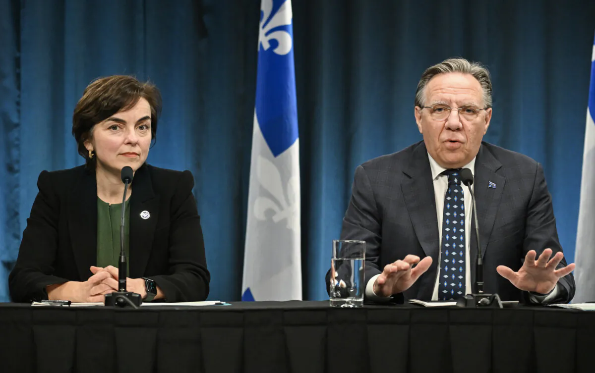 Quebec Economy Minister Christine Fréchette looks on as Quebec Premier François Legault speaks during a news conference in Montreal, on April 3 2025. (The Canadian Press/Graham Hughes) 