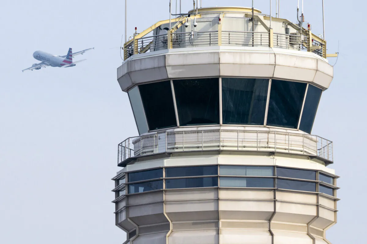An American Airlines Airbus A319 takes off past the air traffic control tower at Ronald Reagan Washington National Airport in Arlington, Va., on Jan. 11, 2023. (Saul Loeb/AFP via Getty Images)