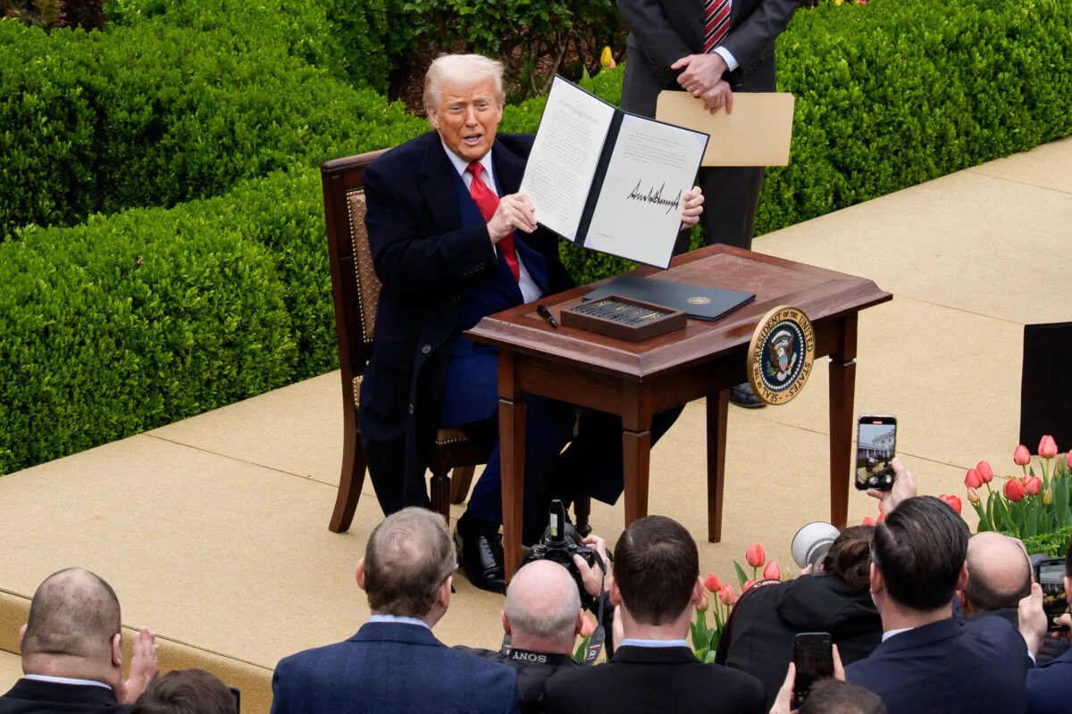 President Donald Trump signs an executive order imposing tariffs on imported goods during a 'Make America Wealthy Again' trade announcement event in the Rose Garden at the White House in Washington on April 2, 2025. (Andrew Harnik/Getty Images)