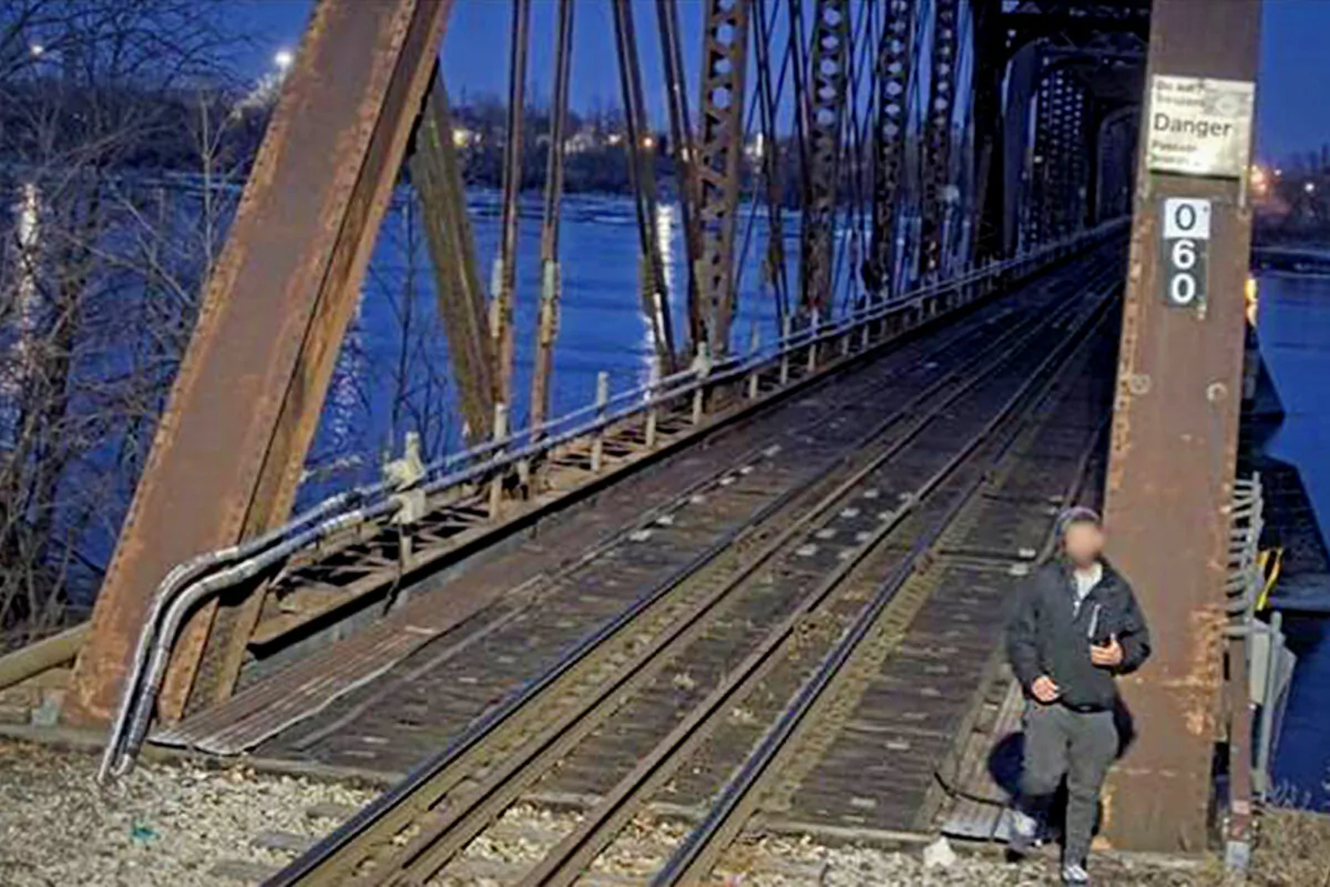An image shows a man standing beside the Fort Erie International Railway Bridge, near Niagara Falls. (Courtesy of the RCMP)