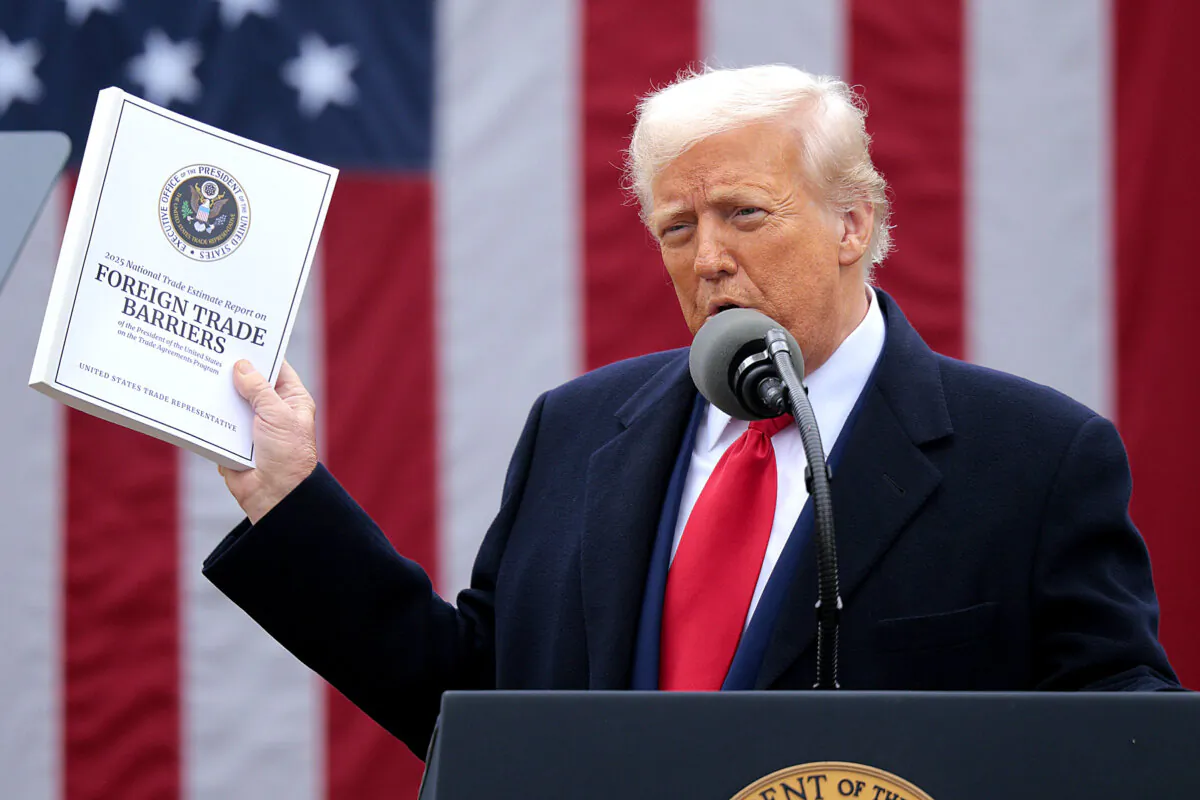 President Donald Trump holds up a copy of a 2025 National Trade Estimate Report as he speaks during a “Make America Wealthy Again” trade announcement event in the Rose Garden at the White House on April 2, 2025. (Chip Somodevilla/Getty Images)