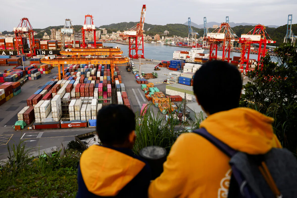 Children view the area from a lookout point over cranes and containers at the Port of Keelung, Taiwan, on April 3, 2025. (Ann Wang/Reuters)