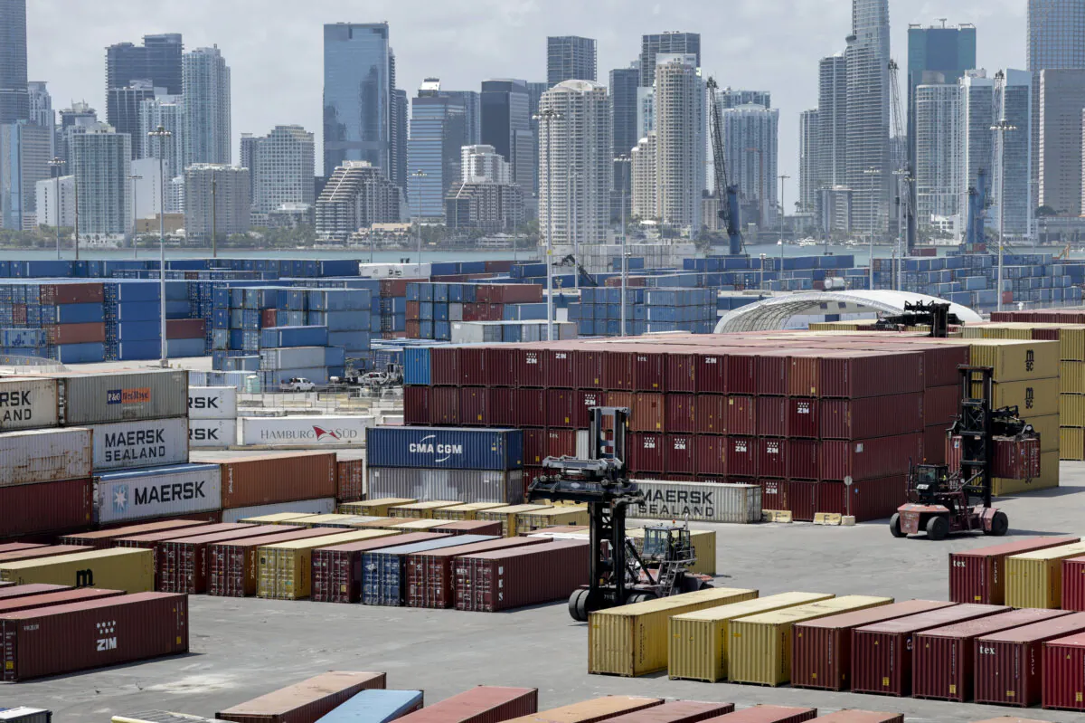 Forklifts move shipping containers at PortMiami in Miami on April 7, 2025. (Joe Raedle/Getty Images)