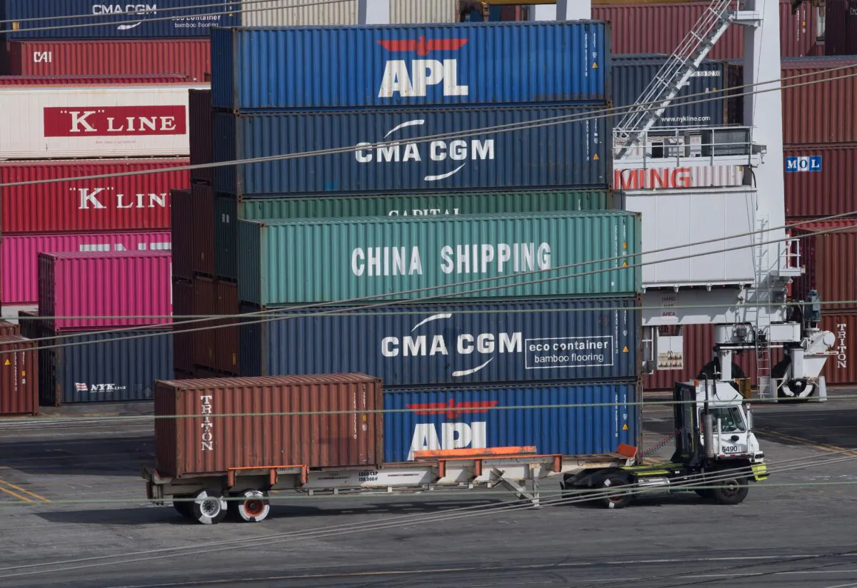 A truck passes by shipping containers at the Port of Los Angeles in Long Beach, Calif., on Sept. 1, 2019. (Mark Ralston/AFP via Getty Images)