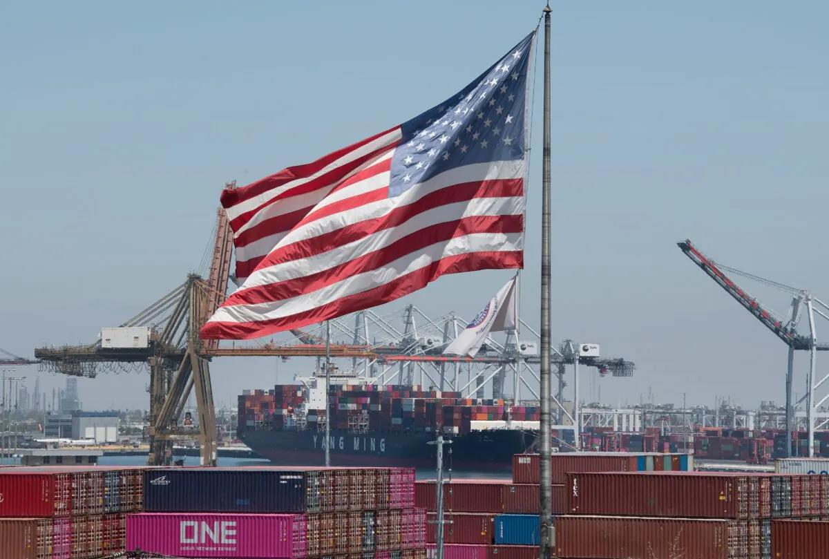 The U.S. flag flies over a container ship unloading cargo from Asia at the Port of Long Beach in  California on Aug. 1, 2019. (Mark Ralston/AFP via Getty Images)