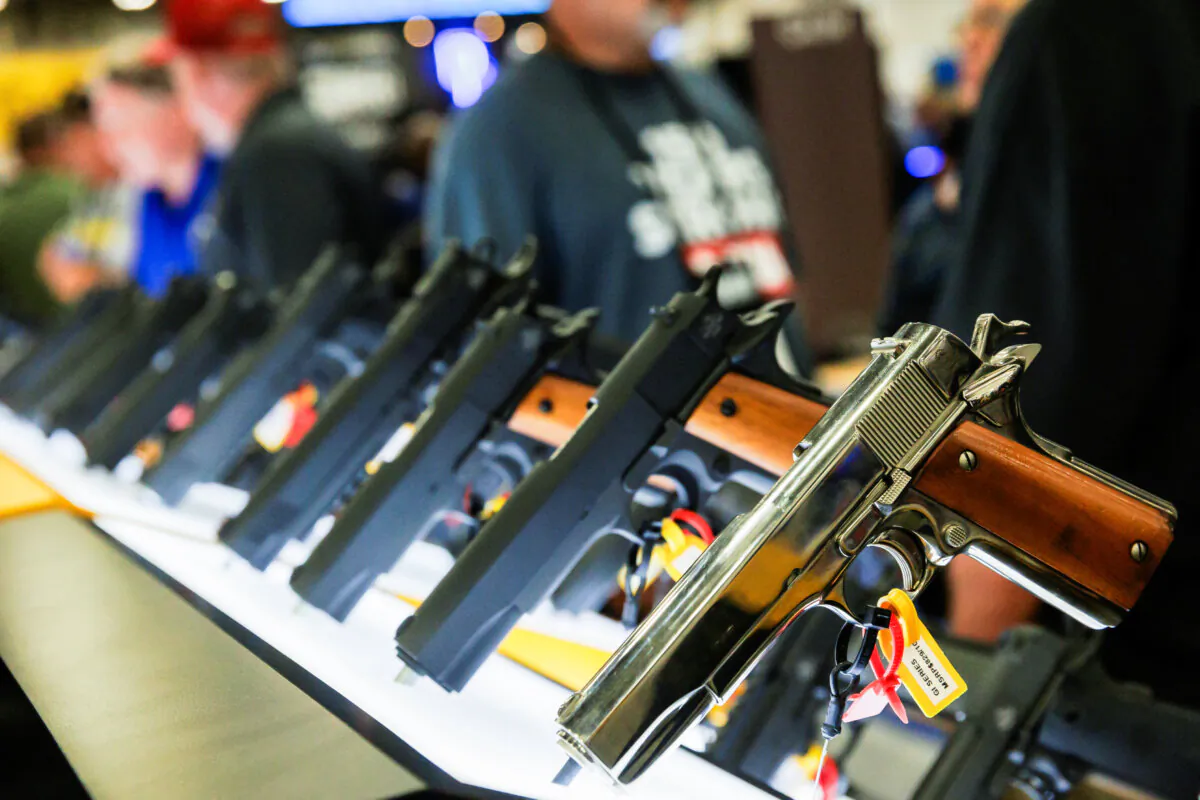 Handguns are displayed in an exhibition booth during the annual National Rifle Association meeting in Dallas on May 17, 2024. (Shelby Tauber/Reuters)