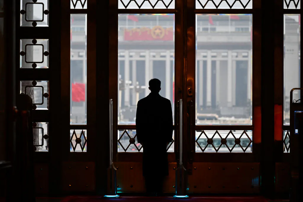 A security guard stands at his post during the opening session of the National People's Congress (NPC) at the Great Hall of the People in Beijing on March 5, 2024. (Photo by WANG Zhao / AFP) (Photo by WANG ZHAO/AFP via Getty Images)