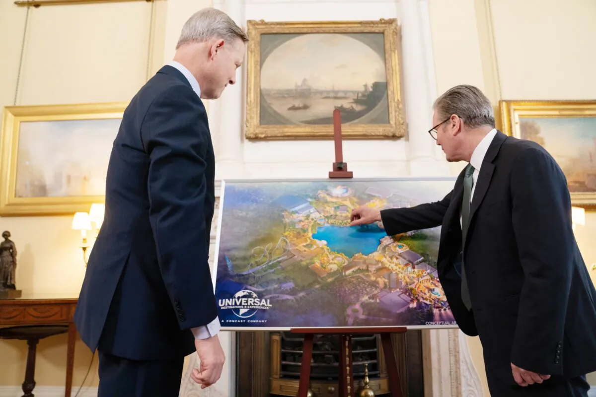Prime Minister Sir Keir Starmer examines an artist’s impression of the new Universal theme park alongside Comcast President Mike Cavanagh, in Downing Street, London, on April 9, 2025. (Stefan Rousseau/PA)