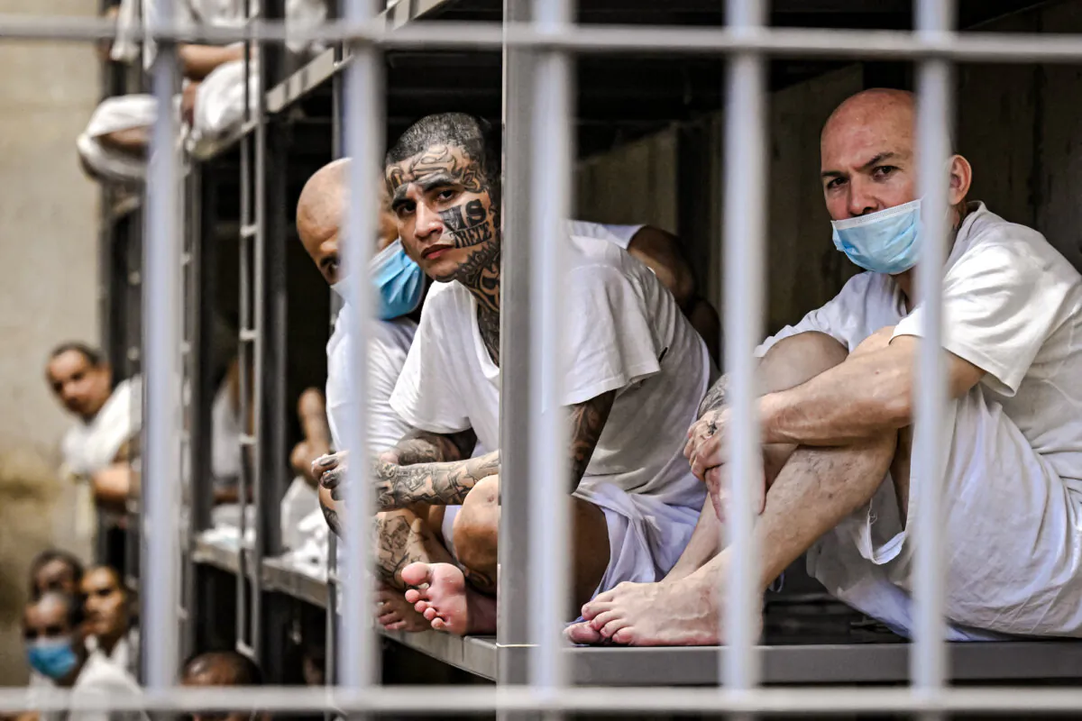 Inmates sit in their cell as Costa Rica's Minister of Security, Gerald Campos, tours the Centre for Terrorism Confinement in Tecoluca, El Salvador, on April 4, 2025. (Marvin Recinos/AFP via Getty Images)