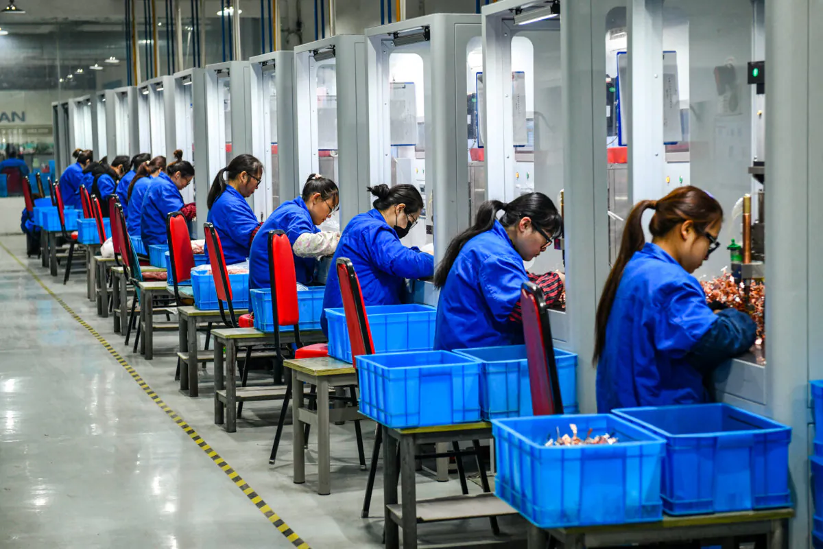 Employees work on a circuit breaker production line at a factory, in this file photo. (STR/AFP via Getty Images)