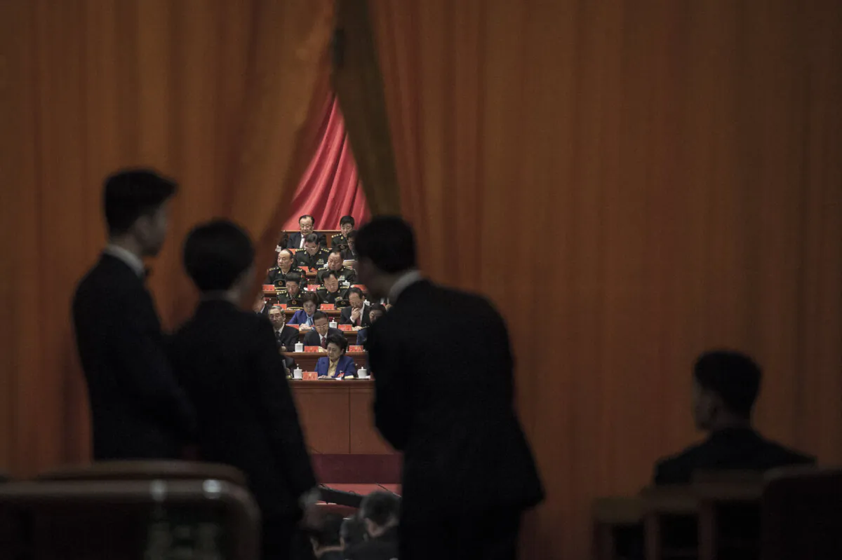 Chinese security guards look at military delegates during the speech of Chinese leader Xi Jinping at the Communist Party's 19th Congress in Beijing on Oct. 18, 2017. (Fred Dufour/AFP via Getty Images)