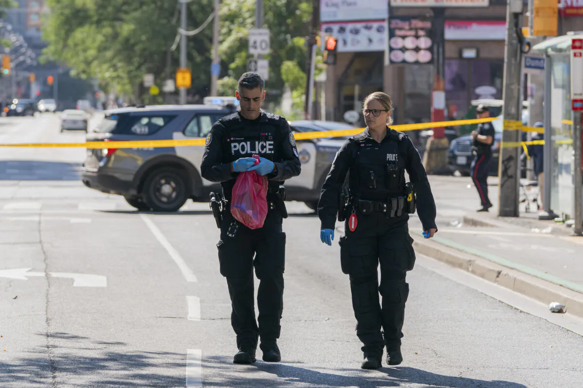 Members of the Toronto Police Service at the scene of a quadruple shooting near the intersection of Dundas Street and Sherbourne Street in Toronto on Sept. 16, 2023. (The Canadian Press/Spencer Colby) 