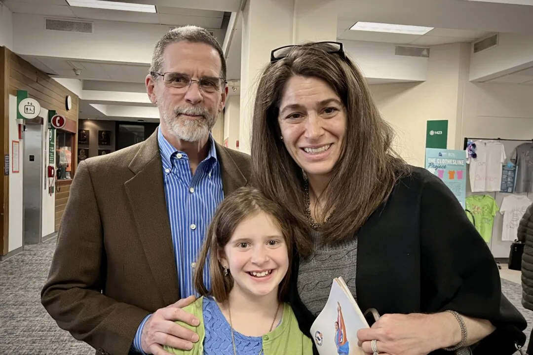 Jeff and Marie Hamlin and their daughter Eve attend Shen Yun Performing Arts at the Center for Performing Arts at Governors State University on April 12, 2025. (Stacy Tang/The Epoch Times)