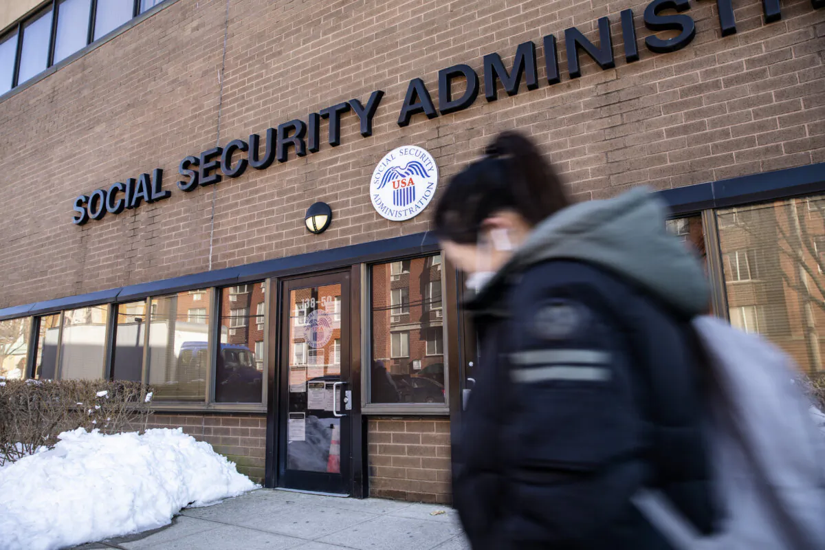 A woman walks past a Social Security Administration office in Flushing, New York City, on Feb. 10, 2021. (Chung I Ho/The Epoch Times)
