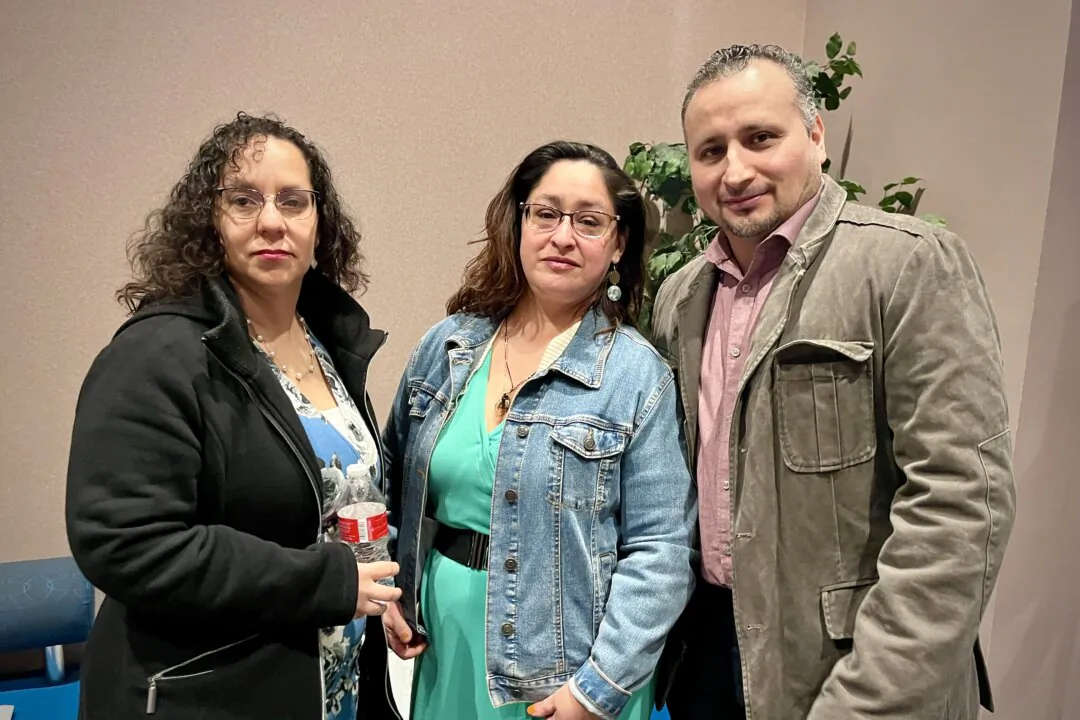Juan Carlos Hernandez (far R) attended a Shen Yun Performing Arts performance with a cousin and a friend at The Center for Performing Arts at Governors State University in Illinois on April 12, 2025. (Stacey Tang/The Epoch Times)