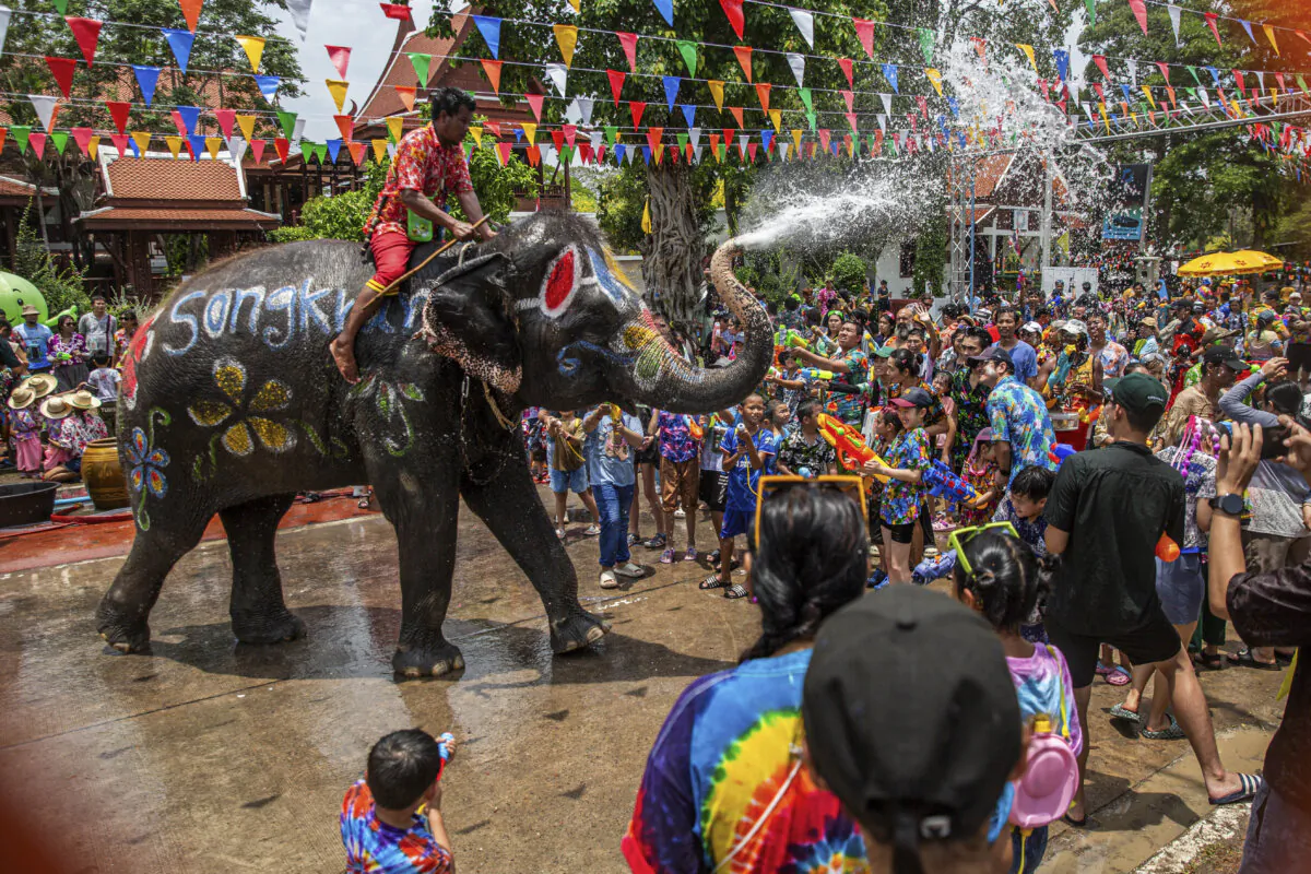 Elephants spray water on partygoers during Songkran in Phra Nakhon si Ayutthaya, Thailand, on April 13, 2025. Songkran, Thailand’s traditional New Year festival, takes place each April, the hottest month of the year. During the holiday, both locals and tourists celebrate by joining in water fights across the country. (Lauren DeCicca/Getty Images)