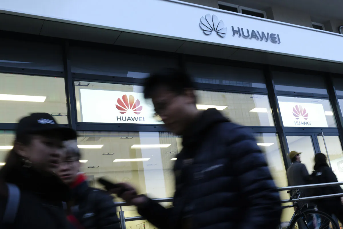 People walk past a Huawei customer service center in Berlin on March 12, 2019. (Sean Gallup/Getty Images)