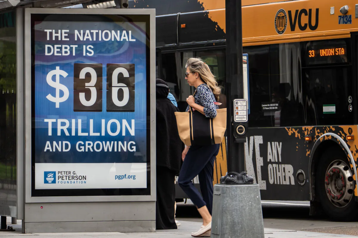 The national debt clock is displayed at a bus station in Washington on April 14, 2025. (Madalina Vasiliu/The Epoch Times)