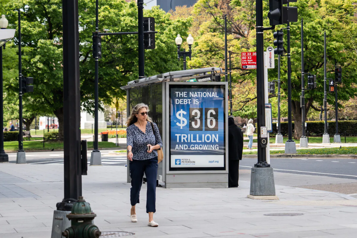 The national debt clock is displayed at a bus station in Washington on April 14, 2025. (Madalina Vasiliu/The Epoch Times)
