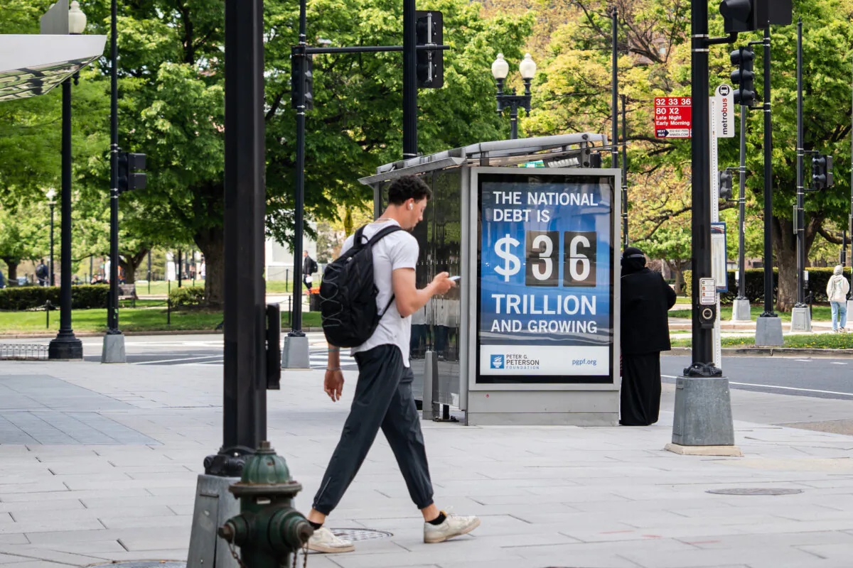 The national debt clock is displayed at a bus station in Washington on April 14, 2025. (Madalina Vasiliu/The Epoch Times)