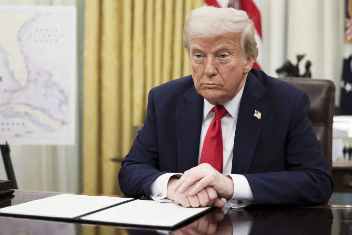 President Donald Trump prepares to sign an executive order in the Oval Office at the White House on March 31, 2025. (Leah Millis/Reuters)