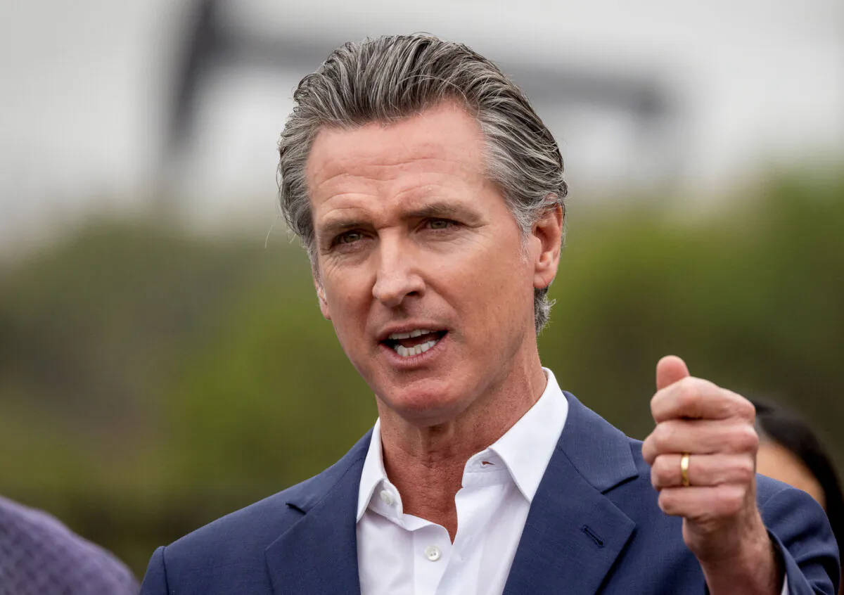 California Gov. Gavin Newsom speaks with oil pumps in the background in Los Angeles on Sep. 25, 2024. (John Fredricks/The Epoch Times)