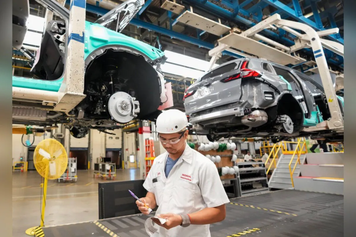 Honda employees work along the vehicle assembly line before an event announcing plans for a Honda electric vehicle battery plant in Alliston, Ont., on April 25, 2024. (The Canadian Press/Nathan Denette)