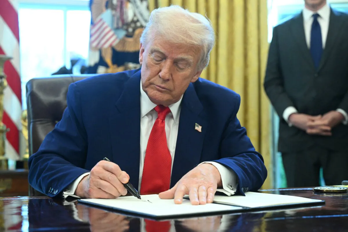 U.S. President Donald Trump signs an executive order in the Oval Office of the White House in Washington on April 9, 2025. (Saul Loeb/AFP via Getty Images)