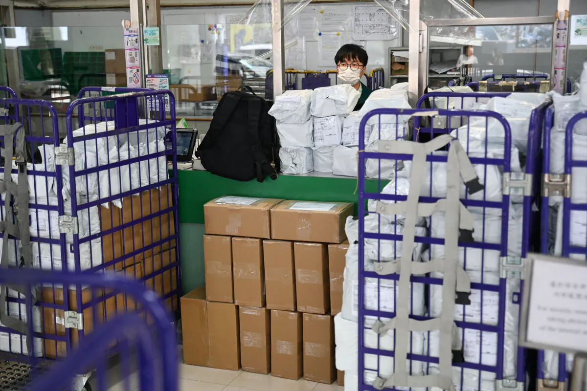 A Hongkong Post employee stands at a service counter in a post office in Hong Kong on April 16, 2025. (Peter Parks/AFP via Getty Images)