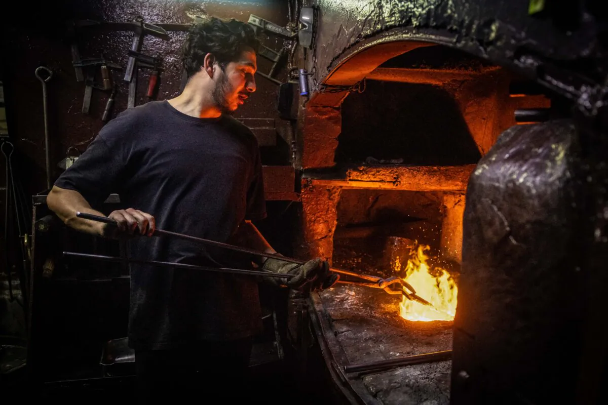 A man smelts recycled gold jewelry into a gold bar in Istanbul's Grand Bazaar in Istanbul on April 17, 2025, as gold prices surge past the $3,300 per ounce mark. (Chris McGrath/Getty Images)