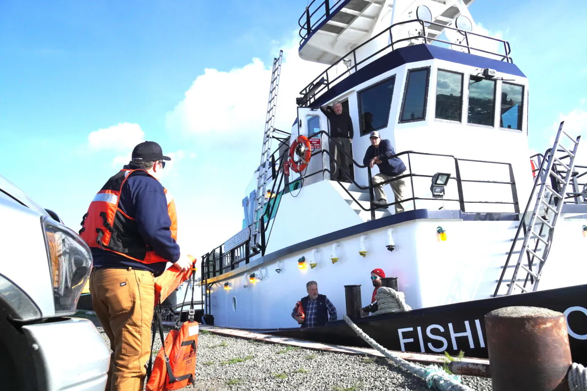 Max Rosenberg (L), Vane Brothers Co. Port Engineer for California, prepares to board the tugboat Fishing Creek moored in the Alameda Harbor on April 8, 2025. (Allan Stein/The Epoch Times)