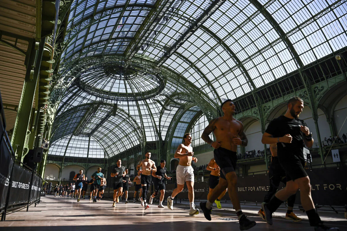 Participants run during the Hyrox fitness race at the Grand Palais venue in Paris on April 18, 2025. (Julien de Rosa/AFP via Getty Images)