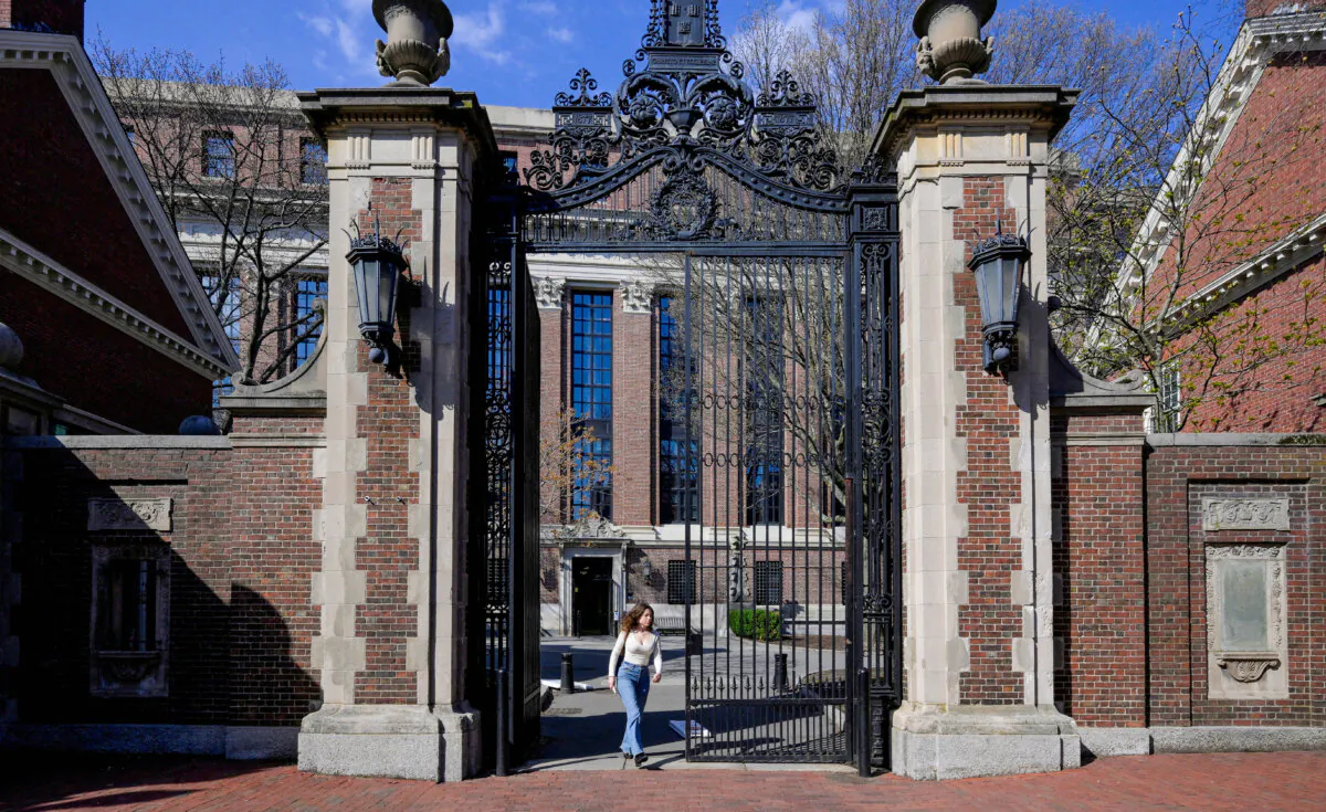 A woman walks on the campus of Harvard University in Cambridge, Mass., on April 15, 2025. (Faith Ninivaggi/Reuters)