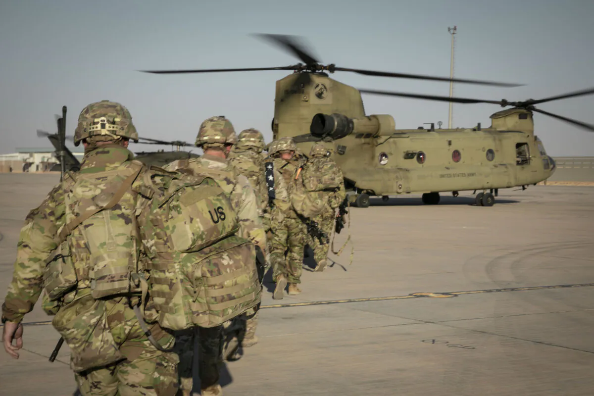 U.S. Army soldiers load a CH-47 Chinook in support of Combined Joint Task Force—Operation Inherent Resolve near Al-Tanf Garrison, Syria, on Oct. 29, 2024. (Staff Sgt. Mahsima Alkamooneh/U.S. Army)