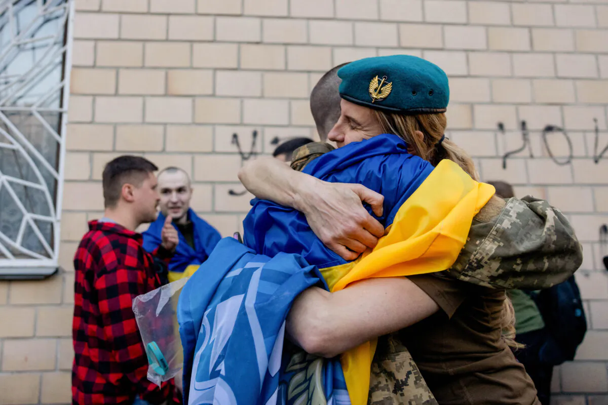 A freed Ukrainian prisoner hugs a relative after an exchange at an undisclosed location in Ukraine on April 19, 2025. (Tetiana Dzhafarova / AFP via Getty Images)