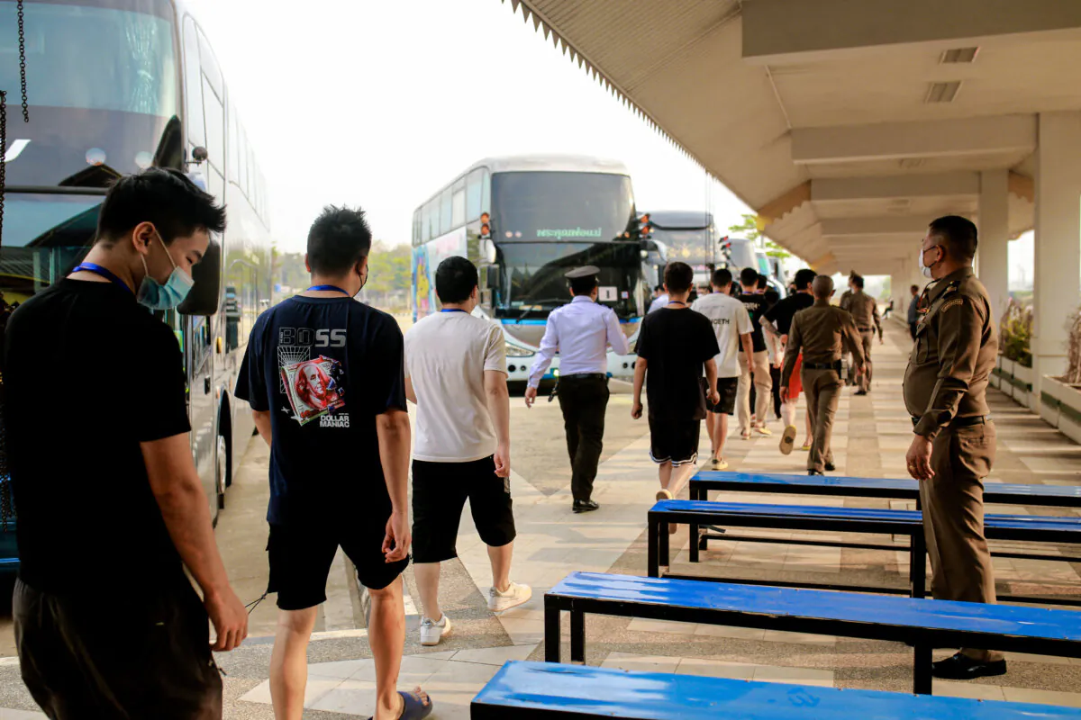 Scam center workers and victims from China arrive at the border checkpoint with Thailand, in Myawaddy, Burma, on Feb. 20, 2025. Hundreds of Chinese workers were heading home after being freed from online scam centers. (STR/AFP via Getty Images)