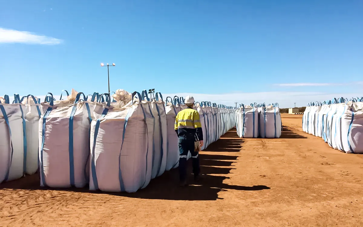 A Lynas Corp worker walks past sacks of rare earth concentrate waiting to be shipped to Malaysia, at Mount Weld, northeast of Perth, Australia, on Aug. 23, 2019. (Melanie Burton/Reuters)