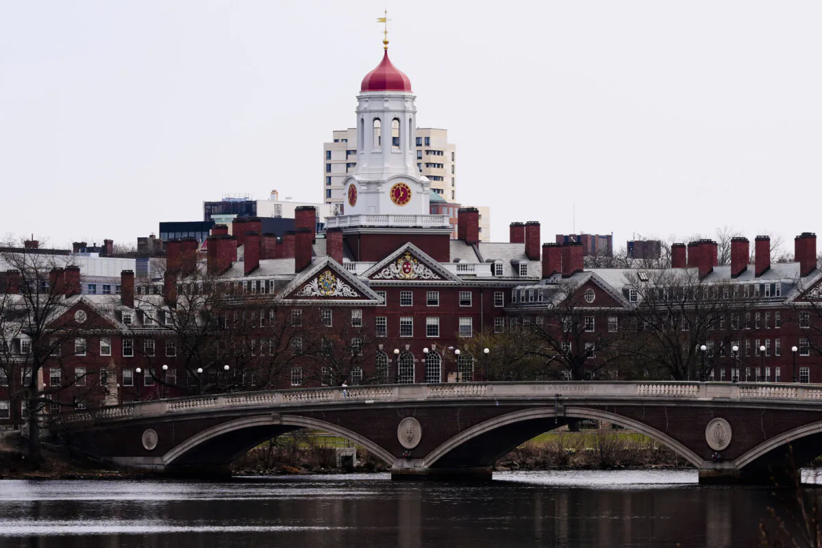 Water flows down the Charles River near Harvard University in background in Cambridge, Mass., on April 15, 2025. (Charles Krupa/AP Photo)
