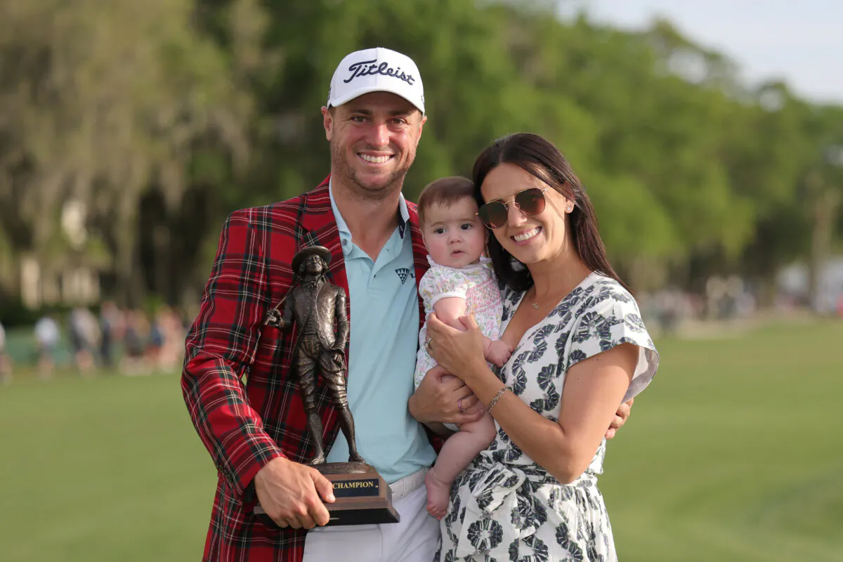 Justin Thomas of the United States poses with wife, Jillian Wisniewski, daughter, Molly Grace, and the championship trophy after winning the final round of the RBC Heritage 2025 at Harbour Town Golf Links in Hilton Head Island, South Carolina on April 20, 2025. (Andrew Redington/Getty Images)