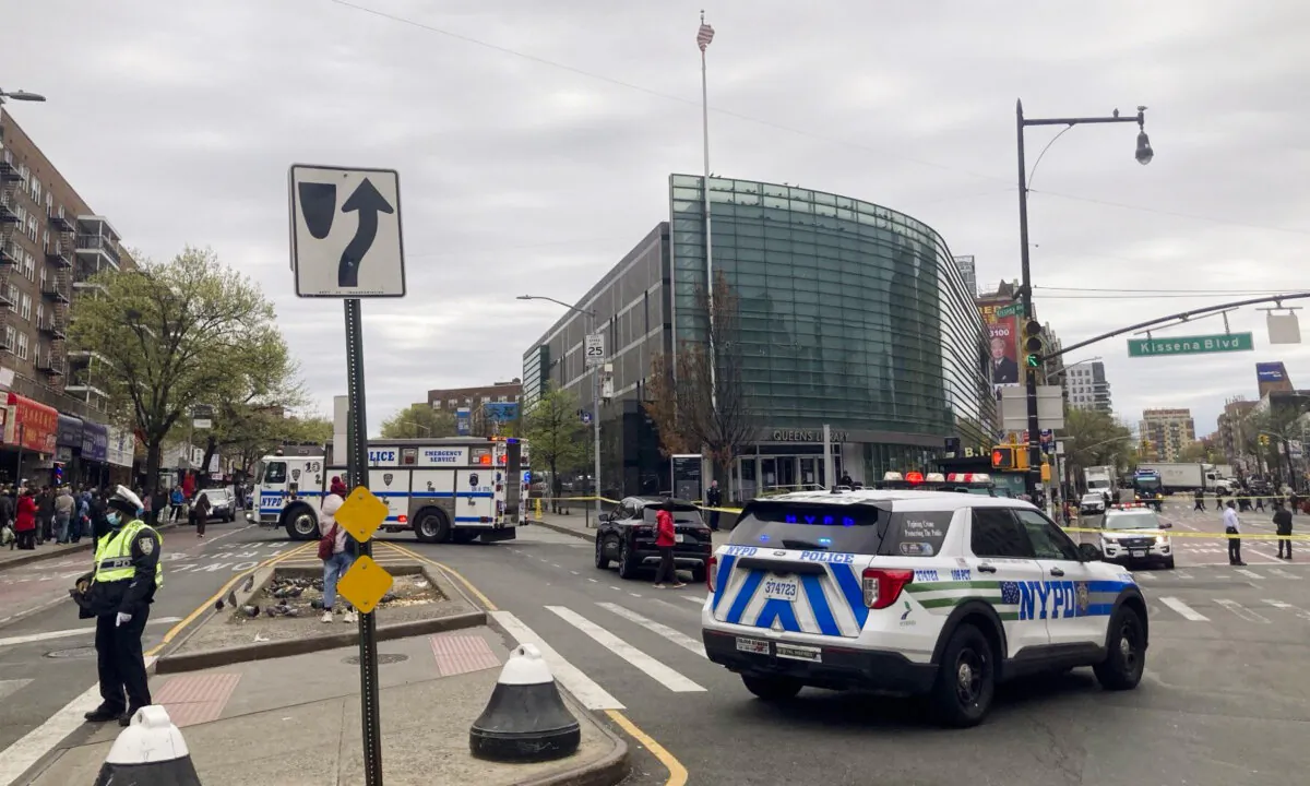 Police cars surround Queens Public Library in the Flushing neighborhood of Queens in New York City on April 21, 2025. (The Epoch Times) 