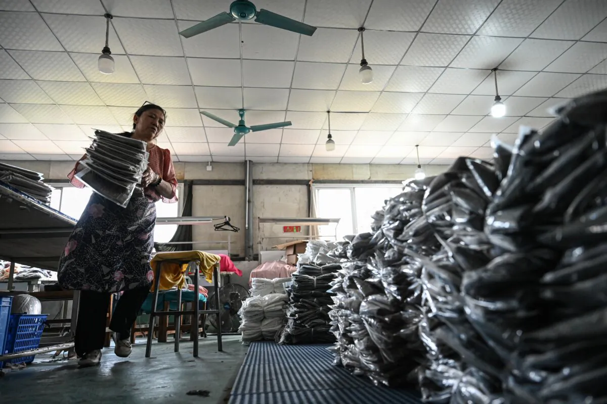 An employee sorts garments for an e-commerce company at a clothing factory in Guangzhou, in southern Guangdong Province, China, on April 16, 2025. (Jade Gao/AFP via Getty Images)