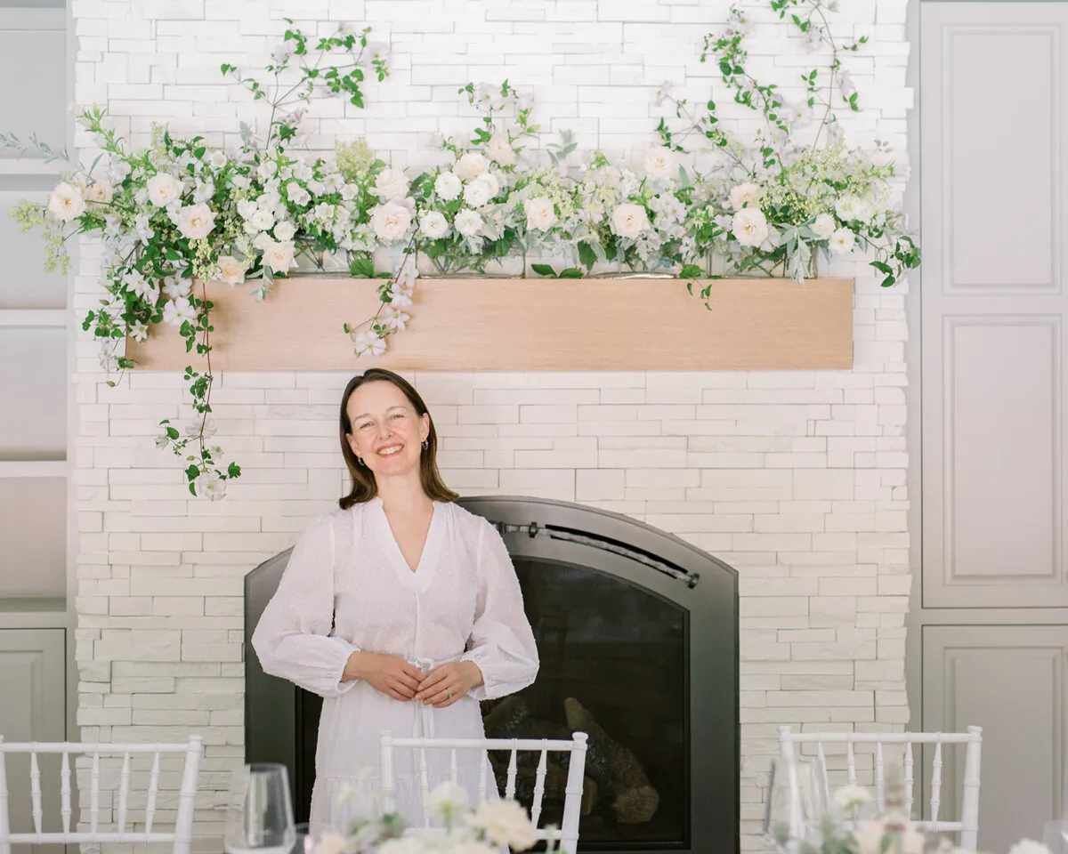 For an at-home wedding reception in June, Ashley Fox adorned the mantle with Minnesota-grown clematis, campanula, and lady’s mantle, along with California-grown champagne roses. (Märit Williams Photography)