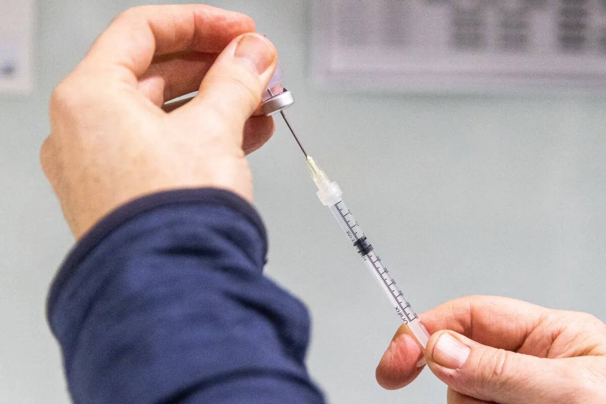 A pharmacist prepares a COVID-19 vaccination booster shot in Melbourne, Australia, on July 11, 2022. (Asanka Ratnayake/Getty Images)