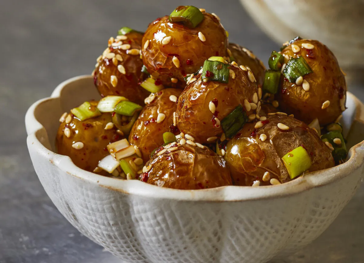 These tender, creamy potatoes are tossed in a salty-sweet sauce and finished with sesame seeds and green onions. (America's Test Kitchen/Kritsada Panichgul)