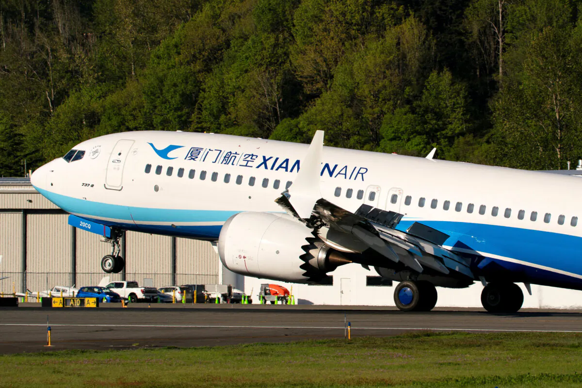 A Boeing 737 MAX 8, the second jet intended for use by a Chinese airline to be returned to its manufacturer, lands at Boeing Field in Seattle on April 22, 2025. (David Ryder/Reuters)