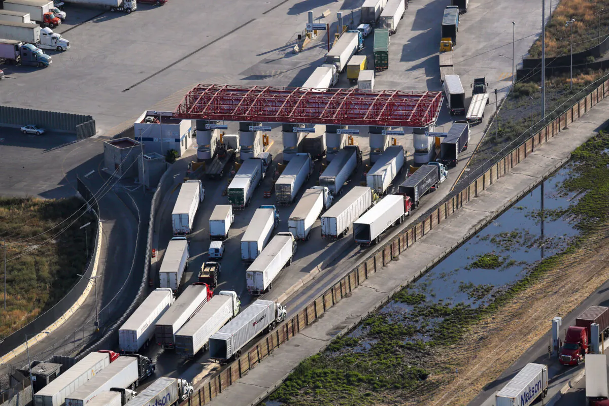 Freight trucks pass through customs before entering the United States at the Otay Mesa port of entry in San Diego, in an undated file photo. (John Moore/Getty Images)