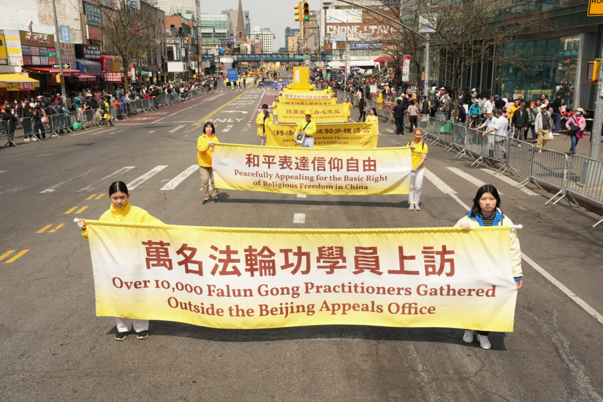 Falun Gong practitioners attend a parade to call for the end of the persecution in China and commemorate the 26th anniversary of the April 25, 1999, appeal in Beijing, in the Flushing neighborhood in Queens, N.Y., on April 19, 2025. (Larry Dye/The Epoch Times)
